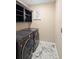 Convenient laundry room with washer, dryer, and built-in shelving at 108 Blanco Dr, Deland, FL 32724