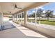 Enclosed patio with ceiling fans offering a view of the stone paved patio and fenced backyard at 108 Blanco Dr, Deland, FL 32724