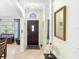 Bright entryway with a dark wood front door and decorative mirror at 1081 Treadway Dr, Deltona, FL 32738