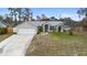 House exterior with a driveway and a grassy yard at 1081 Treadway Dr, Deltona, FL 32738