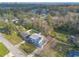 Aerial view shows the home's yard, neighborhood and proximity to trees at 1195 10Th St, Daytona Beach, FL 32117