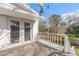 Back deck with stairs, a white railing and a view of the backyard and garden at 1195 10Th St, Daytona Beach, FL 32117