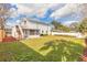 Large backyard with screened patio and deck access at 1195 10Th St, Daytona Beach, FL 32117