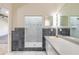 Bathroom with tiled shower, vanity lighting and a large mirror at 1195 10Th St, Daytona Beach, FL 32117