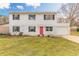 Charming two-story home featuring a bright red door, lush lawn, and a brick facade at 1195 10Th St, Daytona Beach, FL 32117