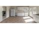 Bright kitchen features white cabinetry and appliances with tile flooring and natural light streaming through french doors at 1195 10Th St, Daytona Beach, FL 32117