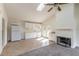 Bright kitchen features white cabinetry, appliances, fireplace, and natural light with a skylight and a ceiling fan at 1195 10Th St, Daytona Beach, FL 32117