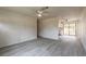 Open living room with gray wood flooring, a ceiling fan, and a view of the kitchen at 1195 10Th St, Daytona Beach, FL 32117