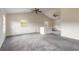 Bright living room featuring vaulted ceilings, neutral carpet, and a ceiling fan at 1195 10Th St, Daytona Beach, FL 32117