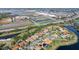 Aerial image of a neighborhood with houses with pools, roads, lakes and commercial buildings at 1372 Lombardi Ct, Poinciana, FL 34759