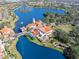 Stunning aerial view of community center nestled alongside a lake with lush landscaping at 1372 Lombardi Ct, Poinciana, FL 34759