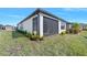 Exterior shot of home's screened in patio with a view of the yard at 1372 Lombardi Ct, Poinciana, FL 34759