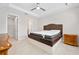 Clean bedroom showcasing tile floors, neutral paint, and a brown tufted headboard at 1372 Lombardi Ct, Poinciana, FL 34759