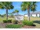 Arese community entrance sign nestled among palm trees, lush grass, and manicured bushes at 1372 Lombardi Ct, Poinciana, FL 34759