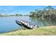 Private dock on a serene lake, perfect for boating and enjoying the natural surroundings at 1372 Lombardi Ct, Poinciana, FL 34759