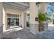 Elegant entrance with stone accents, professional landscaping, and a 'The Palms' sign at 1372 Lombardi Ct, Poinciana, FL 34759