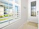 Bright entryway with decorative window shutters and stylish front door at 1372 Lombardi Ct, Poinciana, FL 34759