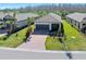 Charming single-story home with a brick paver driveway, well-maintained landscaping, and a two-car garage at 1372 Lombardi Ct, Poinciana, FL 34759