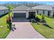Charming single Gathering home boasting a brick driveway and attached garage in a well manicured community at 1372 Lombardi Ct, Poinciana, FL 34759