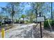 Golf cart parking area available with neatly arranged parking spots, greenery, and trees at 1372 Lombardi Ct, Poinciana, FL 34759