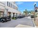 Row of parked golf carts along a picturesque street showcasing community transportation and convenient lifestyle at 1372 Lombardi Ct, Poinciana, FL 34759