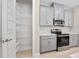 Modern kitchen featuring stainless steel appliances, gray cabinets, granite countertops, and a convenient pantry at 1372 Lombardi Ct, Poinciana, FL 34759