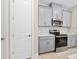 Kitchen view of stainless steel oven and microwave combo with light gray cabinets, white counters and marble tile backsplash at 1372 Lombardi Ct, Poinciana, FL 34759