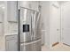 Modern kitchen featuring a stainless steel refrigerator with matching light gray cabinets, white counters and tile backsplash at 1372 Lombardi Ct, Poinciana, FL 34759