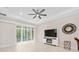 Bright living room with sliding glass doors, tray ceiling, recessed lighting, and a modern ceiling fan at 1372 Lombardi Ct, Poinciana, FL 34759