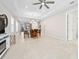 Open-concept living area and dining with neutral colors and tile flooring throughout at 1372 Lombardi Ct, Poinciana, FL 34759