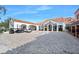 An exterior shot of the parking area featuring a white building with Spanish-style roofing and golf carts at 1372 Lombardi Ct, Poinciana, FL 34759