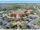 Aerial view of a resort-style pool, lush landscaping and parking at community center at 1372 Lombardi Ct, Poinciana, FL 34759