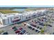 Aerial view of a commercial center with a variety of stores and a full parking lot at 1372 Lombardi Ct, Poinciana, FL 34759