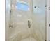 Modern bathroom shower featuring seamless glass enclosure and marble tile at 1372 Lombardi Ct, Poinciana, FL 34759