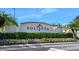 Stone Solivita welcome sign with decorative flowerbeds, lush green hedges, and a blue sky backdrop at 1372 Lombardi Ct, Poinciana, FL 34759