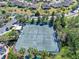 Aerial view of community tennis courts surrounded by lush landscaping and palm trees at 1372 Lombardi Ct, Kissimmee, FL 34759