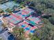 Aerial view of community tennis courts with multiple courts, shaded areas, and parking at 1372 Lombardi Ct, Poinciana, FL 34759