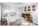 Cozy bedroom featuring a metal-framed bed, wood flooring, and a bookcase at 149 Sheryl Dr, Deltona, FL 32738