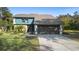 Beautiful two-story home featuring a two-car garage, stone accents, and mature landscaping at 149 Sheryl Dr, Deltona, FL 32738