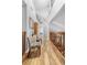 Bright hallway offering wood flooring and overlooks the downstairs living room at 149 Sheryl Dr, Deltona, FL 32738