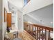 Bright hallway offering wood flooring and overlooks the downstairs living room at 149 Sheryl Dr, Deltona, FL 32738