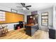 Well-lit home office featuring wood floors, ceiling fan, large desk with built-ins, and storage solutions at 149 Sheryl Dr, Deltona, FL 32738