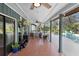 Expansive screened-in patio with tile floor leading to the pool and a seating area perfect for Gathering gatherings at 149 Sheryl Dr, Deltona, FL 32738