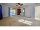 Bright bedroom with patio access, ceiling fan and mirrored closet doors at 1500 Oak Forest Dr, Ormond Beach, FL 32174