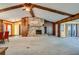 Living room with a stone fireplace, high ceilings, and wood beams at 1500 Oak Forest Dr, Ormond Beach, FL 32174