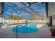 Relaxing kidney-shaped pool with a screened enclosure at 1500 Oak Forest Dr, Ormond Beach, FL 32174