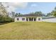 Expansive backyard with lush green lawn and a view of the home's rear facade at 163 Chrysanthemum Dr, Ormond Beach, FL 32174