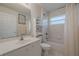 Bright bathroom featuring a shower-tub combo, single vanity, and built-in storage shelf at 163 Chrysanthemum Dr, Ormond Beach, FL 32174