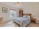 Comfortable bedroom with a window, ceiling fan, and furnishings including a nightstand and dresser at 163 Chrysanthemum Dr, Ormond Beach, FL 32174
