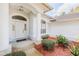 Inviting front entrance with decorative columns, an arched window, and a meticulously landscaped garden at 163 Chrysanthemum Dr, Ormond Beach, FL 32174